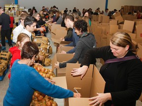More than 150 volunteers were on hand to help pack 2,000 Christmas hampers in three hours at the Frontenac Mall for the annual Jerome Taylor Memorial/Whig-Standard Christmas Hampers of Hope Fund. (Julia McKay/The Whig-Standard)