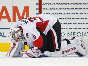 Ottawa Senators goalie Andrew Hammond kneels on the ice after he was hurt during a scrum against the New York Islanders on Dec. 18. (AP)