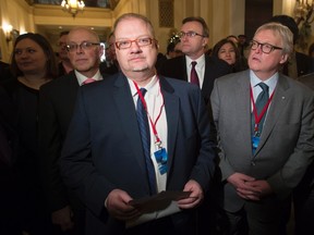 Manitoba Health Minister Kelvin Goertzen, (centre left), Quebec Health Minister and Social Services Minister Gaetan Barrette (centre right) and other provincial health ministers wait to speak as a group before a meeting with the federal finance and health ministers in Ottawa on Monday. (THE CANADIAN PRESS/Adrian Wyld)