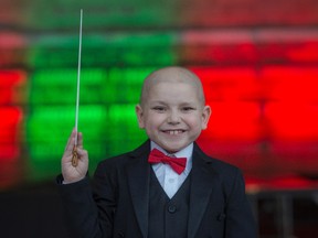 Jordan Cartwright, 7 is battling leukemia, loves classical music and he wanted to conduct an orchestra. He is getting to live his wish of conducting the Edmonton Symphony Orchestra and conducted the national anthem. Shaughn Butts / Postmedia