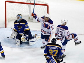 Edmonton Oilers' Ryan Nugent-Hopkins (93) celebrates along side teammate Andrej Sekera, of Slovakia, after scoring past St. Louis Blues goalie Carter Hutton (40) and Blues' Alex Pietrangelo (27) during overtime of an NHL hockey game Monday, Dec. 19, 2016, in St. Louis. The Oilers won 3-2 in overtime. (AP Photo/Jeff Roberson)