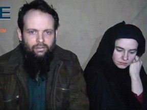 This undated militant file image from video posted online in August 2016, which has not been independently verified by The Associated Press, provided by SITE Intel Group, shows Canadian Joshua Boyle and American Caitlan Coleman, who were kidnapped in Afghanistan in 2012. Officials in Canada are calling for the unconditional release of Boyle and his wife following the release of another video on Monday, Dec. 19, 2016, that appears to show them begging for their governments to intervene with their Afghan captors on their behalf. (SITE Intel Group via AP, File)