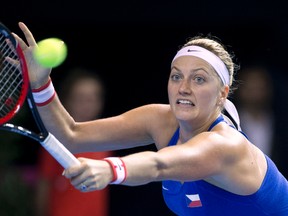 In this Nov. 12, 2016 file picture Czech Republic's Petra Kvitova returns the ball to France's Caroline Garcia during the Fed Cup final in Strasbourg, eastern France. Two-time Wimbledon champion Petra Kvitova has been injured during an attack in her flat in the Czech Republic. Kvitova’s spokesman Karel Tejkal says Tuesday Dec. 20, 2016 Kvitova suffered a left hand injury and has been treated by doctors. (AP Photo/Jean-Francois Badias,file)