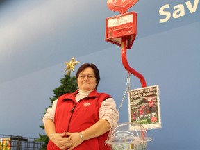 Zena Rutter, a second year Christmas Kettle volunteer with the Salvation Army, staffed a kettle at the Woodstock Walmart during peak shpping hour after work on Monday, Dec. 19, 2016. (MEGAN STACEY/Sentinel-Review)