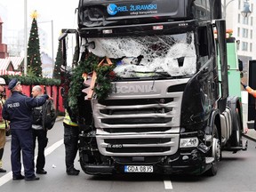 Emergency personnel stand next to a truck on December 20, 2016 at the scene where it crashed into a Christmas market near the Kaiser-Wilhelm-Gedaechtniskirche (Kaiser Wilhelm Memorial Church) in Berlin. (Tobias SCHWARZTOBIAS SCHWARZ/AFP/Getty Images)