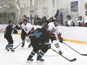 Vulcan Hawks bantam player Joel Campbell works around a Coaldale Cobras player to score a goal, during their game at the Vulcan District Arena Friday evening.