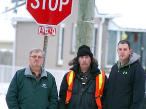 Dennis DeBot, left, and Chad DeBot, right, both with A. DeBot and Sons Ltd., pose with longtime crossing guard Al Welsh. The municipality eliminated Welsh's position at the beginning of this month. In response, A. DeBot and Sons Ltd. is going to pay for Welsh to remain on the job and continue to assist kids crossing at the Murray Street and Reaume Avenue intersection.