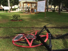 A pentagram erected by atheist Preston Smith lies damaged in Boca Raton's Sanborn Square, Fla. on Tuesday, Dec. 20, 2016. Smith erected the pentagram earlier this month to protest a Nativity scene place in the city-owned square. Vandals apparently dragged down the 300-pound statue using a chain attached to a vehicle. (AP Photo/Terry Spencer)