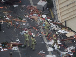 Firefighters look at the debris after the trailer has been towed away from the crime scene in Berlin, Germany, Tuesday, Dec. 20, 2016, the day after a truck ran into a crowded Christmas market and killed several people. (AP Photo/Markus Schreiber)