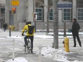 A cyclist uses a  bike lane on Richmond St.  W. on Jan. 13, 2016. (Jack Boland/Toronto Sun)