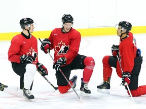 Thomas Chabot, Pierre-Luc Dubois and Mathieu Joseph of Team Canada chat after practice at Canadian Tire Centre in Ottawa on Dec. 20, 2016. (Jean Levac/Postmedia)