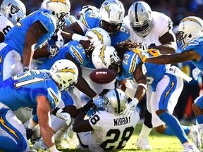 Latavius Murray #28 of the Oakland Raiders fumbles the ball during the first quarter against the San Diego Chargers at Qualcomm Stadium on December 18, 2016 in San Diego, California. (Photo by Harry How/Getty Images)