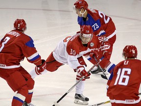 Denmark's Rasmus Thykjaer tries to get past Russia's Mikhail Sidorov, left, Grigory Dronov and Nikita Li during a World Junior Hockey Championship pre-tournament game at the Rogers K-Rock Centre on Tuesday. Russia won 2-1 in overtime. (Ian MacAlpine/The Whig-Standard)