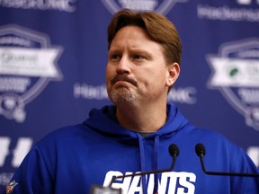 Giants head coach Ben McAdoo was fined $50,000 and the team $150,000 on Tuesday for using a walkie-talkie for about five plays against the Cowboys earlier this month. (Julio Cortez/AP Photo)