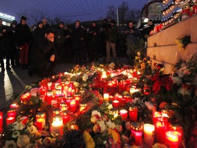 A man prays in front of candles and flowers at candles at Breitscheidtplatz the area after a lorry truck ploughed through a Christmas market on December 20, 2016 in Berlin, Germany. So far 12 people are confirmed dead and at least 48 injured. Authorities have confirmed they believe the incident was an attack and have arrested a Pakistani man who had fled immediately after the attack. Police are investigating the possibility that the truck, which belongs to a Polish trucking company, was stolen yesterday. (Photo by Michele Tantussi/Getty Images)