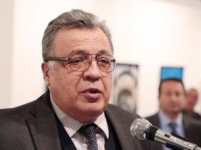 Andrei Karlov, the Russian Ambassador to Turkey, speaks at a photo exhibition in Ankara on Monday, Dec. 19, 2016, moments before a gunman opened fire on him. Karlov was rushed to a hospital after the attack and later died from his gunshot wounds. (AP Photo/Burhan Ozbilici)