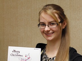 Helena Banman holds a copy of the card bearing her art. Photo courtesy of Palliser Regional Schools