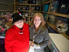 Donna Atkinson-Wilson, left, director of Keeping Kids Warm, and her friend and volunteer Peggy Demelo stand in an east London storage locker where Atkinson-Wilson keeps donated clothes, yarn, and knitted scarves, hats and gloves to be handed out to homeless teens. She?s has been organizing volunteers to help teens in need for 14 years, and gets a great sense of fulfilment from her work. (CRAIG GLOVER, The London Free Press)