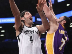 Luis Scola of the Brooklyn Nets puts up a shot against Larry Nance Jr. of the Los Angeles Lakers in the first half at Barclays Center on Dec. 14, 2016. (Michael Reaves/Getty Images)
