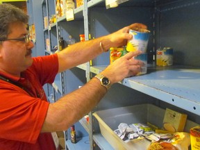 Executive director Myles Vanni checks a shelf at the Inn of the Good Shepherd food bank in this file photo. The John Street agency is serving Christmas dinner at its soup kitchen. (File photo/Sarnia Observer)