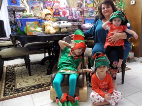 Nine-year-old Ali Barakat, left, his sisters Zaynab, front, and Yasmeena, and mother Linda Barakat show off some of the toys they've collected for children at Victoria Hospital over the holidays. Ali and his family have spent two Christmases in the hospital and want to help brighten the day of kids who are admitted.