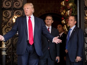 President-elect Donald Trump, left, accompanied by Trump Chief of Staff Reince Priebus, right, and Retired Gen. Michael Flynn, a senior adviser to Trump, center, speaks to members of the media at Mar-a-Lago, in Palm Beach, Fla., Wednesday, Dec. 21, 2016. (AP Photo/Andrew Harnik)