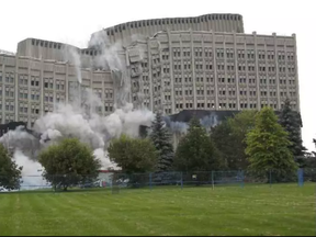 The Sir John Carling Building in mid-implosion in July 2014. The process left toxic chemicals in the former Agriculture Canada headquarters' filled-in basement. (David Kawai, Postmedia)