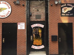 A sign near the front door of the Hells Angels motorcycle club headquarters in New York reads "No Parking Except Authorized Hells Angels," Friday, Dec. 16, 2016. Earlier in the week an out-of-town man was shot after moving an orange cone meant to save a parking space for club members. The secretive group has frustrated police by refusing to help identify the shooter. (AP Photo/Tom Hays
