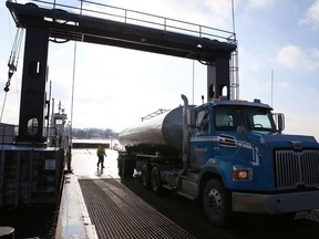 A milk truck drives off Frontenac County’s Howe Island ferry on Wednesday. The lifting of a restriction on heavy agricultural vehicles on the ferry at certain times of the day is being questioned by some island residents. (Elliot Ferguson/The Whig-Standard)
