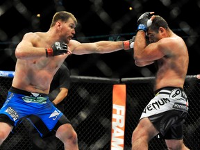 Stipe Miocic (left) punches Gabriel Gonzaga (right) during a UFC match in Chicago on Jan. 25, 2014. Miocic will likely defend his heavyweight belt against the winner of this month's fight between former champions Fabricio Werdum and Cain Velasquez.. (Paul Beaty/AP Photo/Files)