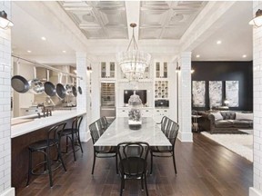 A built-in coffee machine, here below the wine rack, adds a touch of luxury to the daily routine. (SUPPLIED / CALGARY HERALD)