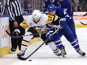 Toronto Maple Leafs' Tyler Bozak strips the puck from Pittsburgh Penguins' Bryan Rust during an NHL game at Air Canada Centre in Toronto on Dec. 17, 2016. (THE CANADIAN PRESS/Jon Blacker)