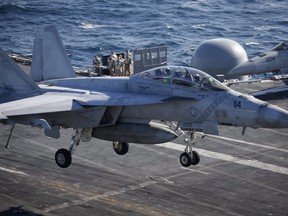 A U.S. Navy F/A-18 Super Hornet fighter is pictured landing on the USS Ronald Reagan in the West Sea, South Korea, in October, 2015. (THE CANADIAN PRESS, AP-KIM HONG-JI/POOL PHOTO VIA AP)