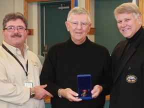 Corunna's Lyle Lalonge received the Governor General's Sovereign's Medal for Volunteers at a brief ceremony during St. Clair Township council meeting this week. From left are The Inn of the Good Shepherd's Myles Vanni, Lyle Lalonge, and St. Clair Township Mayor Steve Arnold. (Carl Hnatyshyn/Postmedia Network)