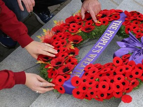 Citizens place poppies on the People's Wreath after the City of Kingston Remembrance Day ceremony on Friday November 11 2016  Ian MacAlpine /The Whig-Standard/Postmedia Network