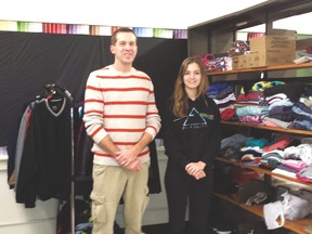 Chris Morris, left, a social worker at West Elgin Secondary School and Rachael Skedgel, display coats collected at the school as part of the annual winter coat drive. This year, WESS joined other agencies in helping to collect and coordinate winter coats.