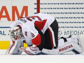 Senators goalie Andrew Hammond kneels on the ice after he was hurt during first period NHL action against the Islanders in New York on Sunday. (Kathy Willens/AP Photo)
