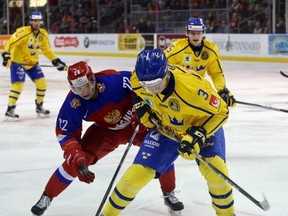 Sweden's Jacob Moverare battles for the puck with Russia's Daniel Yurtaykin during first-period action in a World Junior Hockey Championship pre-tournament game at the Rogers K-Rock Centre on Thursday night. (Ian MacAlpine/The Whig-Standard)