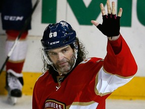Florida Panthers right wing Jaromir Jagr waves to the crowd after being presented with a golden stick during a stoppage in play at an NHL game, in Sunrise, Fla., on Dec. 22, 2016. (AP Photo/Joe Skipper)