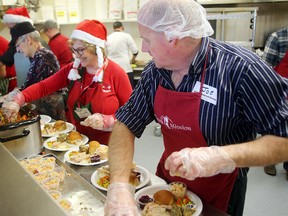 Carole Cockrell (left) and Joe Lepieszo prepare meals for the annual Christmas dinner at Siloam Mission. (Brian Donogh/Winnipeg Sun file photo)