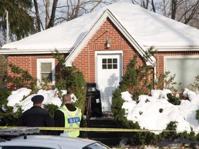 A London police sergeant speaks to a member of the Special Investigations Unit in front of 56 Duchess Ave. where a 35 year old man died after a confrontation with police at in London, Ont. on Friday December 23, 2016. Derek Ruttan/The London Free Press/Postmedia Network