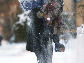 Betty Rosser shovels snow in front of her South Osborne home earlier this week. (CHRIS PROCAYLO/WINNIPEG SUN)