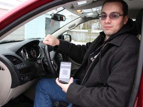 Sarnia Uber driver Jeremy Swoboda is pictured here behind the wheel of his van. The 28-year-old social worker recently decided to become an on-demand private cab driver for Uber in order to supplement his family's income. Barbara Simpson/Sarnia Observer/Postmedia Network