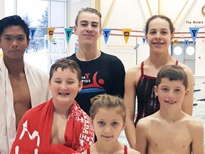 Seven members of the Sarnia Y Rapids I swim team finished first in races at the St. Clair Erie Aquatic League meet Nov. 6 in Windsor. Back row from left are Mark deGuzman, Greg Dietrich and Diane Clarke. Front row from left are Trevor Marut, Ali Page and Darius Landon. Absent is Gabrion Tulang. The team competed again Dec. 4 in Aylmer and returns to the pool Jan. 8 in Chatham. Handout/Sarnia Observer/Postmedia Network