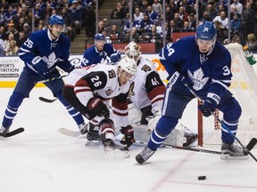 Toronto Maple Leafs centre Auston Matthews (right) tries to play the puck as Arizona Coyotes defenceman Michael Stone (26) and goalie Mike Smith defend during second period NHL hockey action in Toronto, on Thursday December 15, 2016.THE CANADIAN PRESS/Chris Young