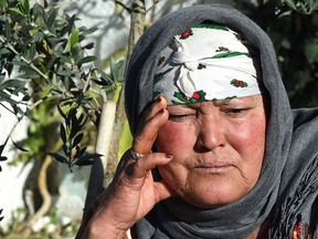 Nour El Houda Hassani, the mother of 24-year-old Christmas market attack suspect Anis Amri, mourns in front of the family house in the town of Oueslatia, in Tunisia's region of Kairouan on Dec. 23, 2016. (FETHI BELAID/AFP/Getty Images)