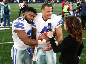 Cowboys' Ezekiel Elliott (left) leans his head on quarterback Dak Prescott as the duo give a post-game interview to Michele Tafoya (right) following their 26-20 win against the Buccaneers in Arlington, Texas, on Sunday, Dec. 18, 2016. (Michael Ainsworth/AP Photo)