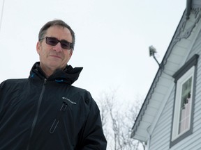 Walter Lenny stands outside his home near Lobo where he uses a wireless receiver, seen protruding from the roofline behind him, to get Internet service. Lenny and other neighbours are frustrated with the lack of reliable Internet service offered to rural residents. (Craig Glover/The London Free Press)