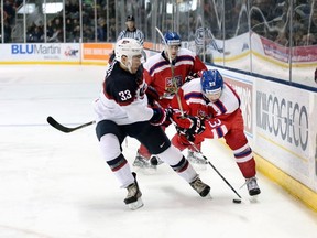 Players from Team USA and the Czech Republic battle for the puck during action at the Rogers K-Rock Centre in Kingston last night. (Adam Smith/For The Toronto Sun)