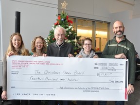 Left to Right: Kristy Hayden, Tamara Kruk, Tracy Drew and Claude Ouellette present a cheque for $14,200 to the Christmas Cheer Board's Kai Madsen (centre) on behalf of the National Microbiology Lab's annual Goft Basket Raffle.